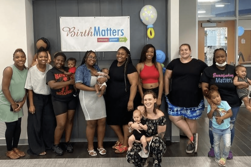 Mothers and BirthMatters staff smiling with their children