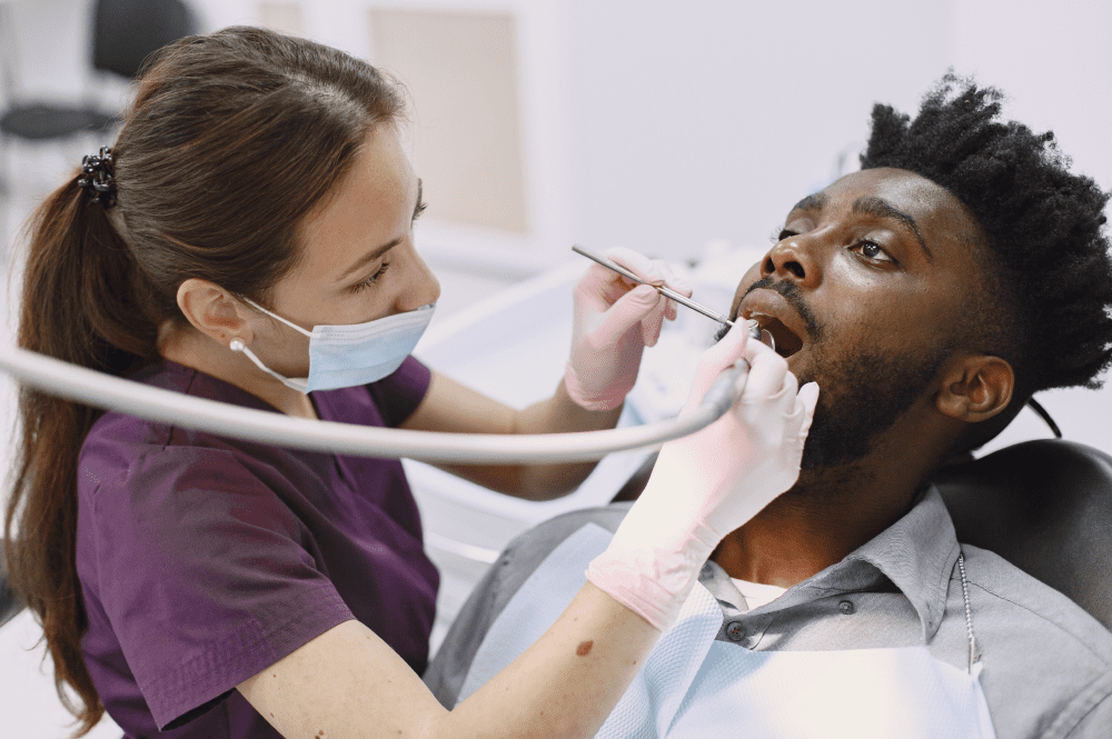 A young man getting an oral health screening and teeth cleaning